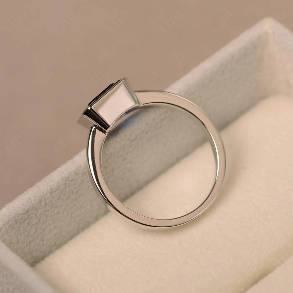 East West Emerald Cut Sapphire Bezel Ring - Image 31