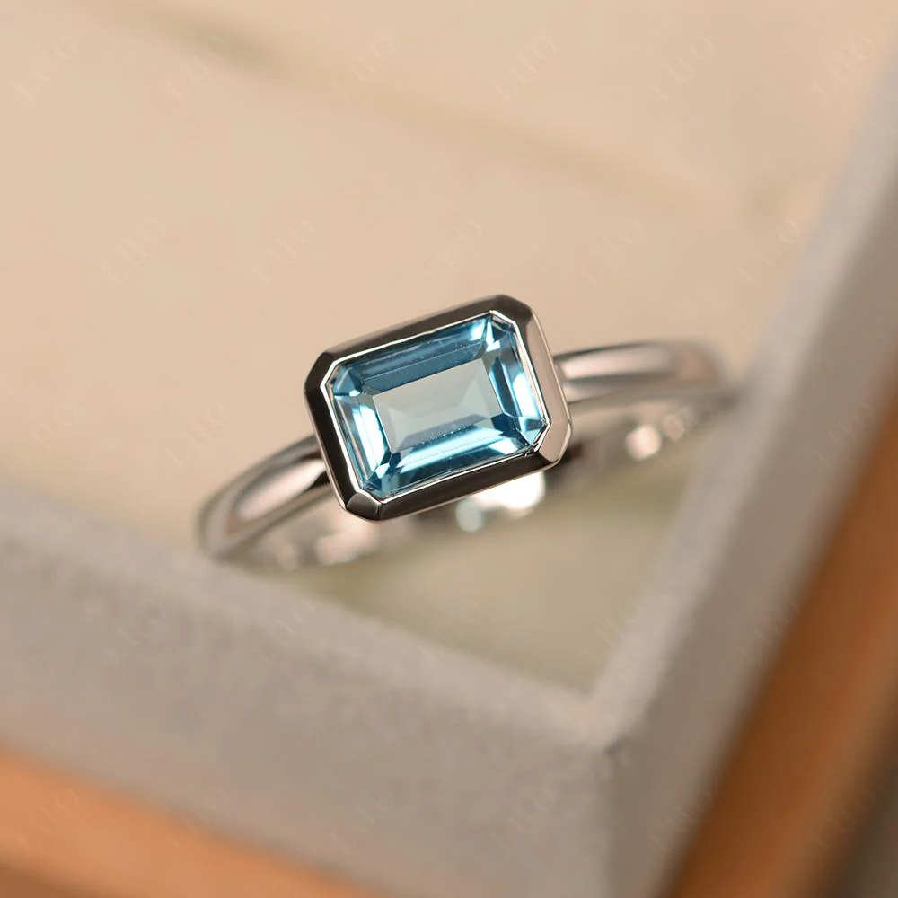 East West Emerald Cut Swiss Blue Topaz Bezel Ring - Image 29