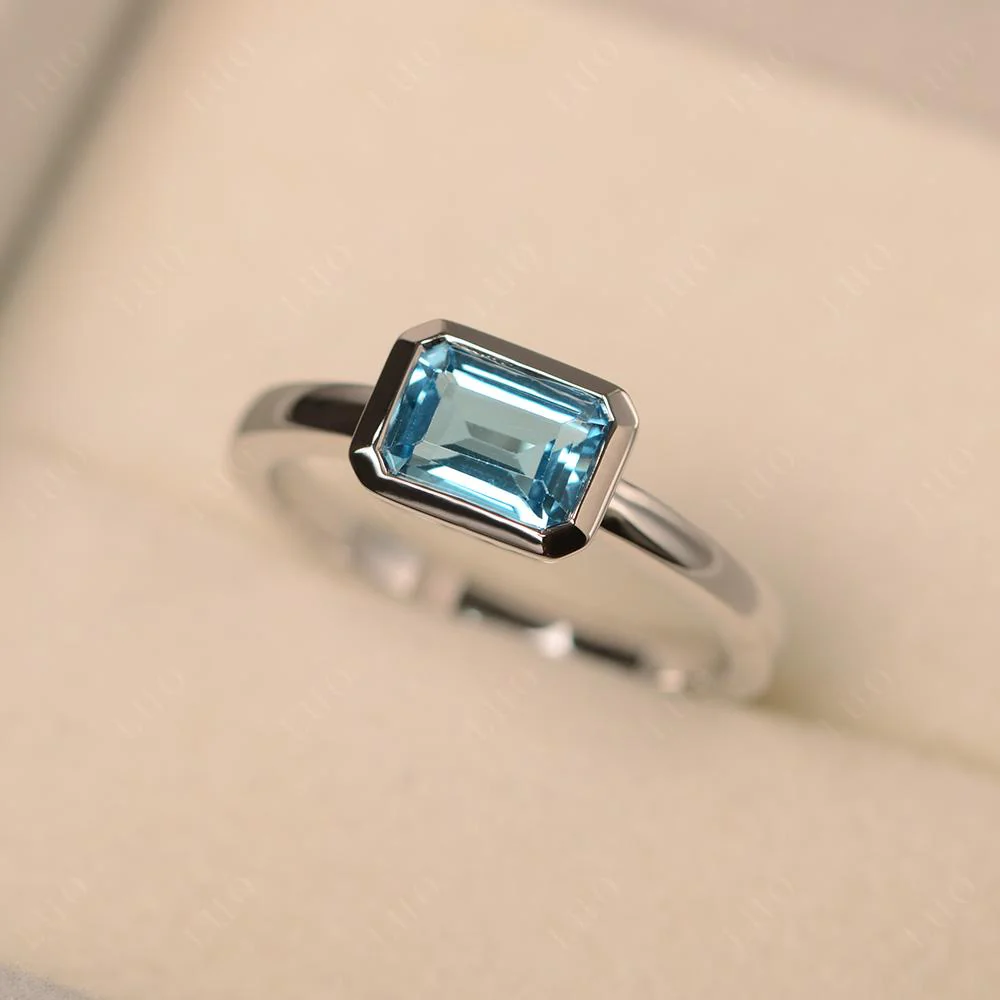 East West Emerald Cut Swiss Blue Topaz Bezel Ring - Image 30