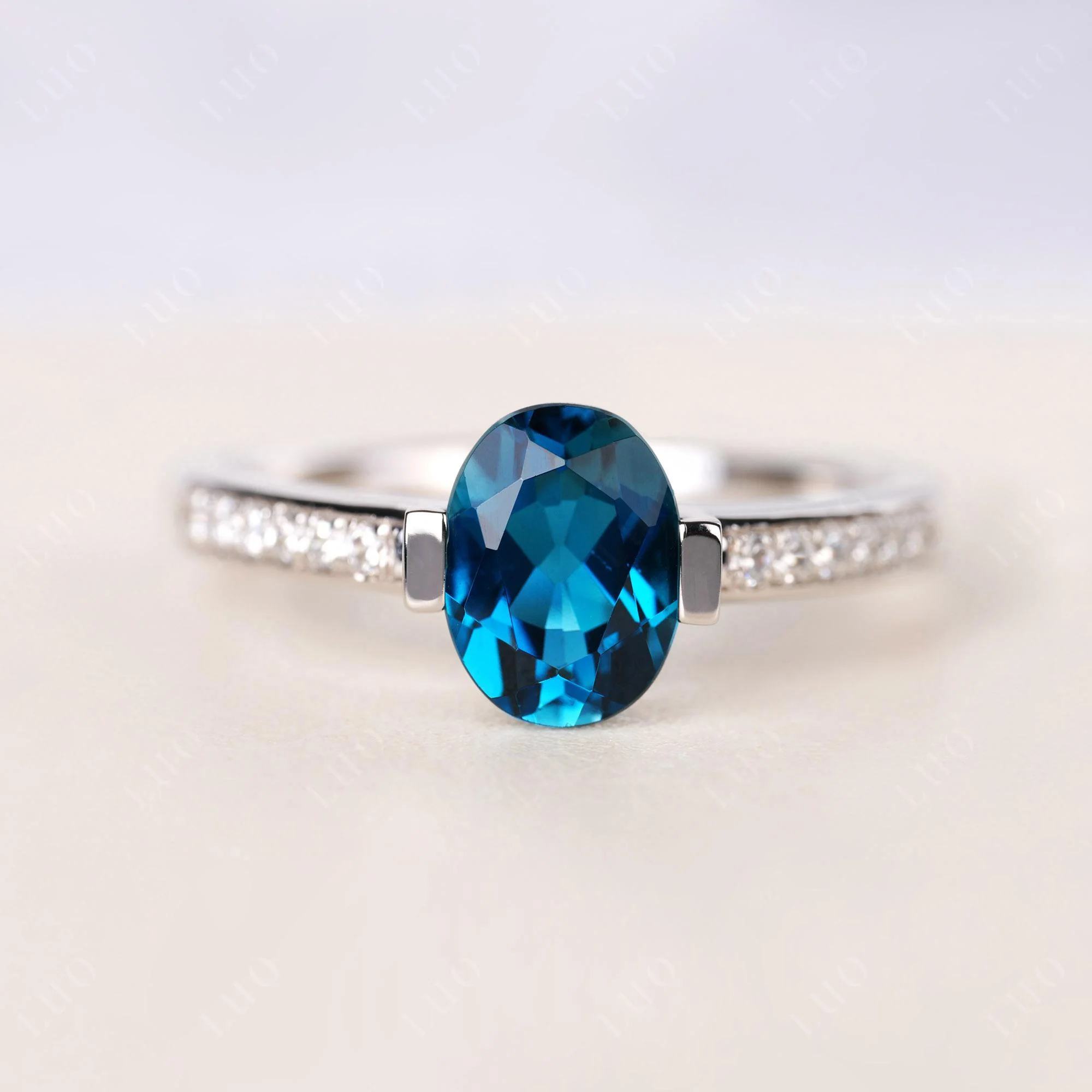 Oval London Blue Topaz Engagement Ring Half Bezel Set