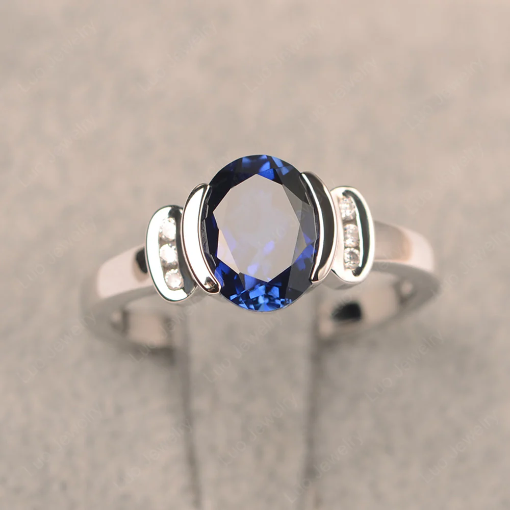 Oval Sapphire Half Bezel Engagement Ring